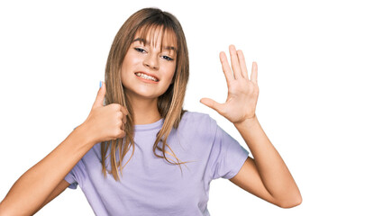 Fototapeta premium Teenager caucasian girl wearing casual clothes showing and pointing up with fingers number six while smiling confident and happy.