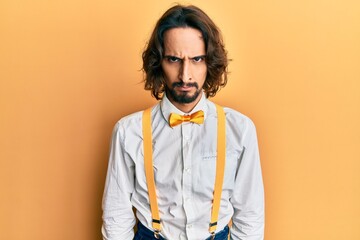 Young hispanic man wearing hipster elegant look skeptic and nervous, frowning upset because of...