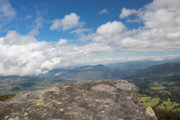 Fototapeta na wymiar Colombian valley countryside and eastern mountains viewed from an ancient monolith called 