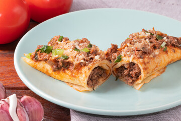 Meat pancake covered with tomato sauce and parmesan cheese.