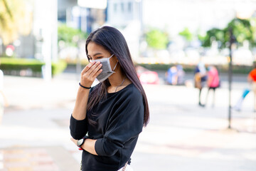 Fototapeta premium Face of Asian woman wearing a face mask for protection virus or pollution with outdoor city background. coronavirus protect. Sick concept and other protect such as Air, Dirt, Fever. Health concept.
