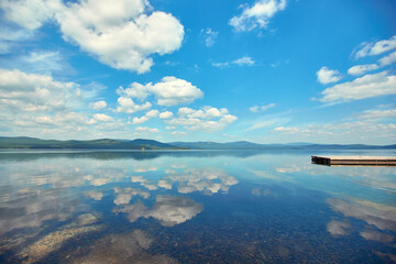 Lake Turgoyak. Russia. The Southern Urals. Clouds are reflected on the water surface of the lake