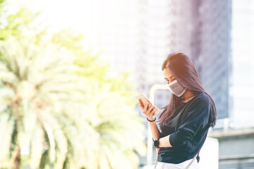 Women wearing mask holding mobile phone background. Protection and Anti coronavirus. (2019-nCoV). New Normal concept.