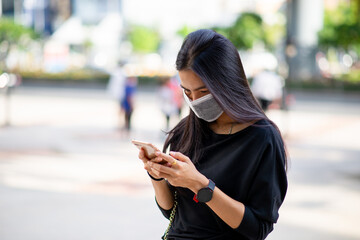 Women wearing mask holding mobile phone background. Protection and Anti coronavirus. (2019-nCoV). New Normal concept.