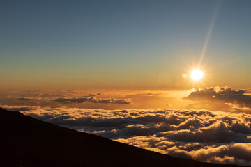 Watching a Maui sunset from above the clouds on a dormant vclcano.