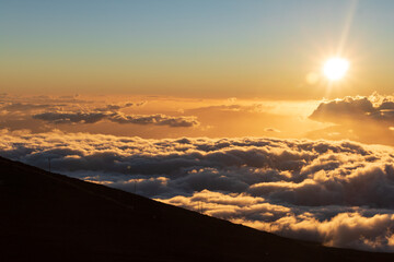 Watching a Maui sunset from above the clouds on a dormant vclcano.