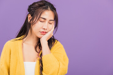 Portrait of Asian beautiful young woman suffering from toothache, female terrible strong teeth pain...