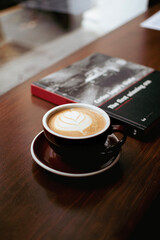 coffee on a table with a book