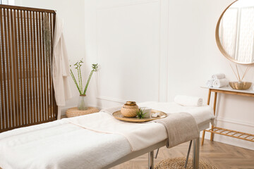 Stylish room interior with massage table in spa salon - obrazy, fototapety, plakaty