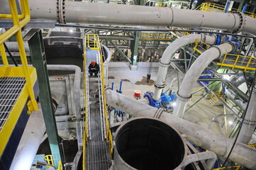 Pavlodar region, Kazakhstan - 12.10.2015 : Pipes and tanks with a centrifuge for processing sulfide...