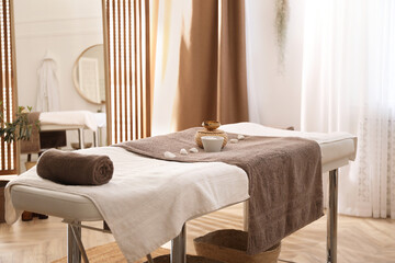 Stylish room interior with massage table in spa salon
