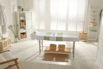 Stylish spa salon interior with massage table - Powered by Adobe