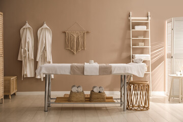 Stylish spa salon interior with massage table
