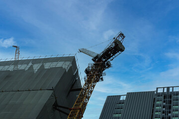 construction site with cranes on space of blue sky background