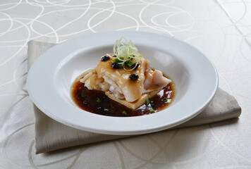 braised grouper fish seafood with tofu in black bean thick soy sauce seafood in white background asian halal menu