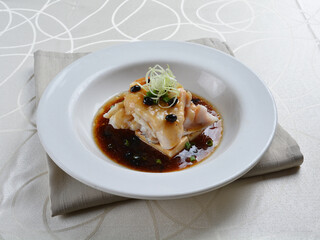 braised grouper fish seafood with tofu in black bean thick soy sauce seafood in white background asian halal menu