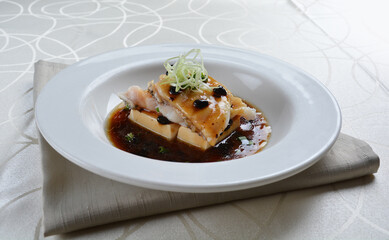 braised grouper fish seafood with tofu in black bean thick soy sauce seafood in white background asian halal menu