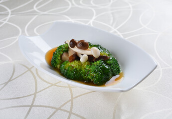 chinese stir fried broccoli with mushroom in soy sauce in white background asian halal menu