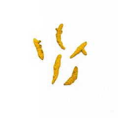 organic yellow curcuma or turmeric fingers or halkund on white background 