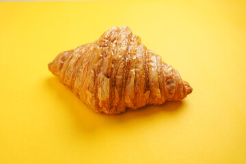 Croissant, on a yellow background, empty space, for breakfast, easy to supply before work.