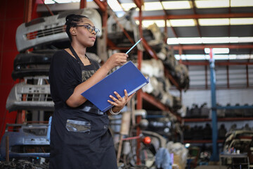 Businessman using laptop computer working or checking stock in warehouse factory, entrepreneurship or business owner concept