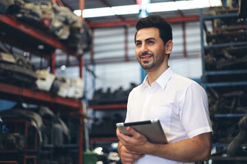 Businessman using laptop computer working or checking stock in warehouse factory, entrepreneurship or business owner concept