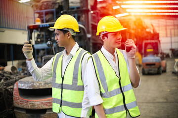 Worker or Engineer work in factory and talk with team by radio, Check stock and inspection in machine spare part engine warehouse