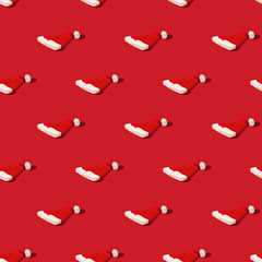 Seamless pattern with Red Santa Claus hat on monohomic background. Minimalistic Christmas composition. 