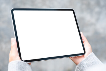 Mockup image of a woman holding digital tablet with blank white desktop screen