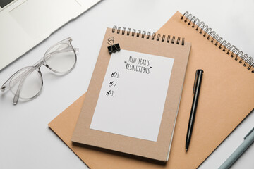 Notebook with empty to-do list for new year on table