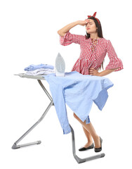 Tired young woman with iron on white background