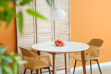 Dining table and folding screen near color wall