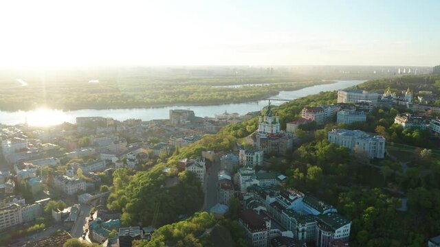 Aerial view of church and cyti. City At Sunset. Aerial view of small old european town. Aerial panoramic view of historic brick buildings. 