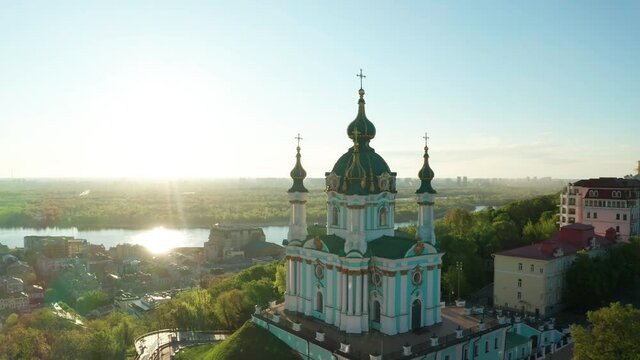 Aerial view of church and cyti. City At Sunset. Aerial view of small old european town. Aerial panoramic view of historic brick buildings. 