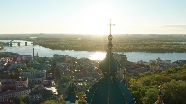 Aerial view of church and cyti. City At Sunset. Aerial view of small old european town. Aerial panoramic view of historic brick buildings. 