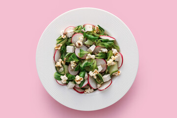 Plate with tasty popcorn salad on color background