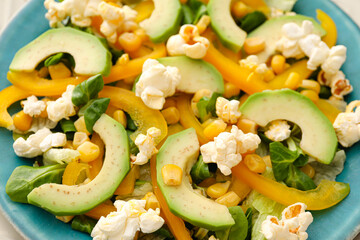 Plate with tasty popcorn salad, closeup