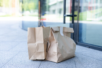 Paper bag near door of house. Safe delivery concept. Contactless home food delivery. Precautionary measures.