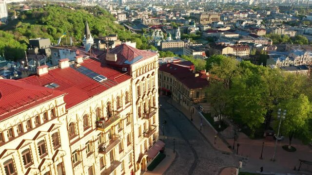 Aerial view of church and cyti. City At Sunset. Aerial view of small old european town. Aerial panoramic view of historic brick buildings. 