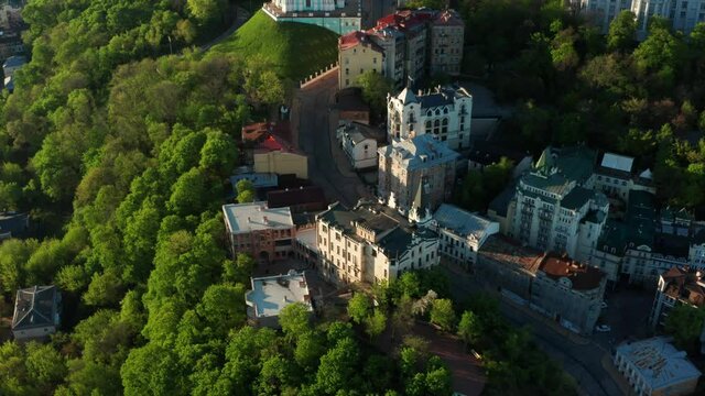Aerial view of church and cyti. City At Sunset. Aerial view of small old european town. Aerial panoramic view of historic brick buildings. 