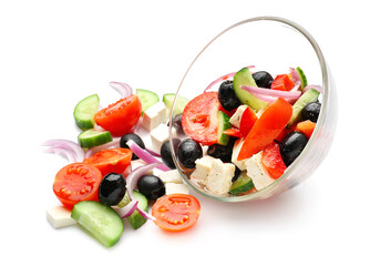 Glass bowl with tasty Greek salad on white background