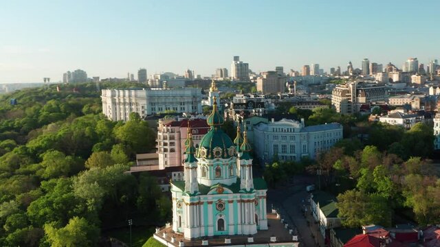 Aerial view of church and cyti. City At Sunset. Aerial view of small old european town. Aerial panoramic view of historic brick buildings. 