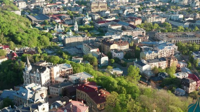 Aerial view of church and cyti. City At Sunset. Aerial view of small old european town. Aerial panoramic view of historic brick buildings. 