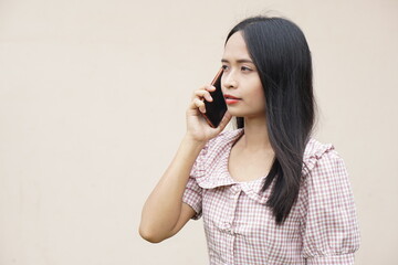 Asian woman talking on the phone about business