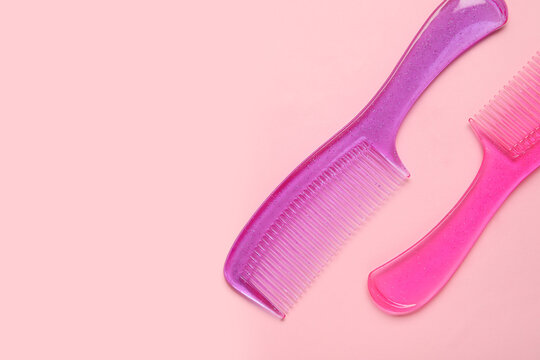 Plastic hair combs on color background