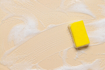 Cleaning sponge with foam on color background