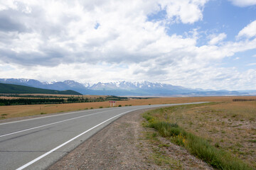 snowy peaks of mountains and steppe on a background of cloudy sky