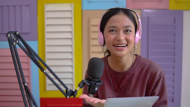 cheerful girl in front of microphone during podcast