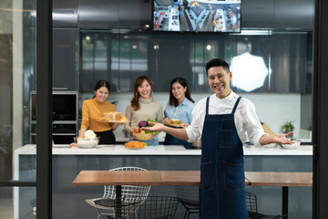 Asian master chef in apron posing invite to enjoy a private group