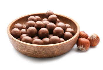 Bowl with tasty chocolate candies and nuts on white background